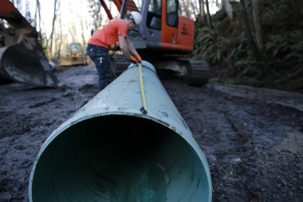 man measuring pipe